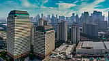 A clear aerial view of modern corporate skyscrapers in Jakarta's business district.