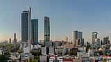 The modern skyline of Mexico City's financial district rises against a clear sky.