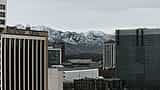 The urban skyline of Salt Lake City sits below the snow-capped peaks of the Wasatch Mountains.