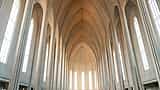 The bright, soaring interior arches of a majestic modern church.
