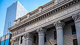 The stone facade and classic columns of a historic United States National Bank building.