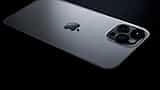 A sleek Apple smartphone with a triple-lens camera rests on a dark surface.