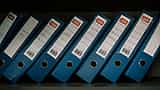 A row of uniform blue document binders arranged neatly on a shelf.