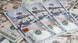 A detailed close-up of a scattered arrangement of United States dollar banknotes.