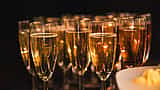 A row of sparkling champagne glasses prepared for a celebratory corporate event.