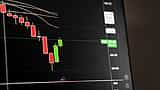 A digital financial screen showing a downward market trend with red candlestick charts.