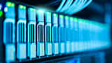 A close-up view of glowing blue lights on a modern data center server rack.
