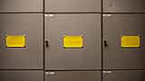 Blank yellow labels sit on the doors of steel filing cabinets.