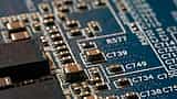 A macro view of an electronic circuit board with intricate metallic traces and components.