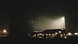 An illuminated industrial facility at a space exploration center at night.