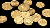 A close-up view of pristine gold coins resting against a dark background.
