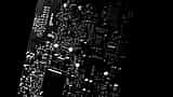 A close-up view of microchips and intricate electronic components on a modern dark circuit board.