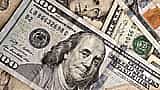 A close-up view of scattered United States dollar bills of various denominations.