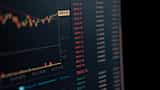 A close-up of a computer screen displaying dynamic financial market data and trading charts.