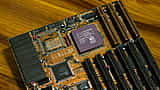 A close-up view of a vintage Advanced Micro Devices AM486 DX processor installed on a computer motherboard.
