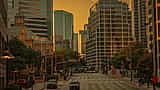 A vibrant golden-hour view of modern skyscrapers illuminating the downtown Dallas skyline.