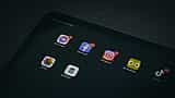 A tablet screen displays app icons for Meta properties including Facebook, Instagram, and Messenger.