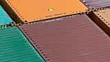 A dense grid of vibrantly colored shipping containers stacked together.