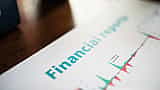 A close-up view of a printed financial report displaying a line graph with green and red performance trends.