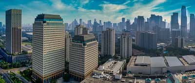 A clear aerial view of modern corporate skyscrapers in Jakarta's business district.