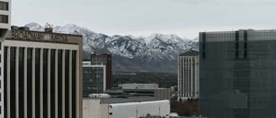 The urban skyline of Salt Lake City sits below the snow-capped peaks of the Wasatch Mountains.