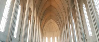 The bright, soaring interior arches of a majestic modern church.