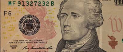 A detailed close-up of a United States ten-dollar bill featuring the portrait of Alexander Hamilton.