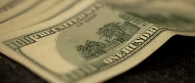 A moody macro close-up of a US one hundred dollar bill.