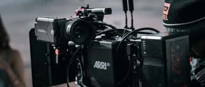 A close-up of a professional ARRI cinema camera rigged on a film set.