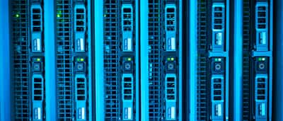 Rows of illuminated server racks in a highly advanced modern data center.