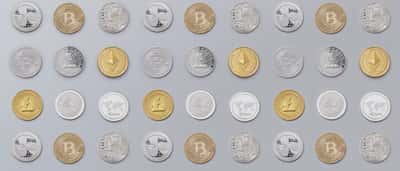 A scattered array of various gold and silver cryptocurrency coins.