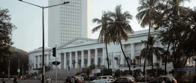 The white tower of the Reserve Bank of India headquarters rises behind the historic Asiatic Society Library in Mumbai.