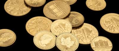 A close-up view of pristine gold coins resting against a dark background.