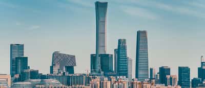 A clear daytime view of modern skyscrapers in Beijing's Central Business District.