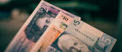 A close-up view of British five and ten pound notes.