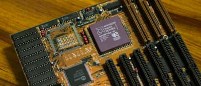 A close-up view of a vintage Advanced Micro Devices AM486 DX processor installed on a computer motherboard.