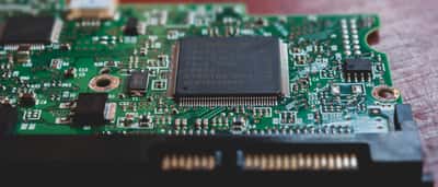 A close-up view of an intricate green computer circuit board with electronic components.