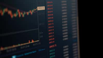 A computer screen displays vibrant financial market data and charts.