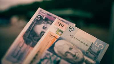 A close-up view of British five and ten pound notes.