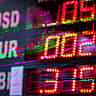 A glowing, dynamic electronic trading board displaying international currencies like USD, EUR, and GBP.
