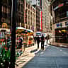 Pedestrians and street vendors at dusk in New York City's Times Square, home to the Nasdaq MarketSite.