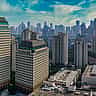 A clear aerial view of modern corporate skyscrapers in Jakarta's business district.