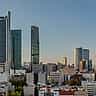 The modern skyline of Mexico City's financial district rises against a clear sky.