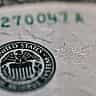 A close-up view of the United States Federal Reserve System seal printed on a dollar bill.