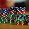 Stacks of colourful poker chips arranged in varying heights on a wooden table.