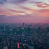 An aerial view of the Tokyo skyline at twilight with glowing city lights.