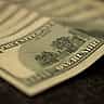 A moody macro close-up of a US one hundred dollar bill.