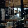 A 'Closed' sign hanging on a dark glass door.