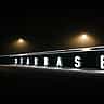 The word Starbase is illuminated in large white letters along a dark wall at night.