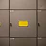 Blank yellow labels sit on the doors of steel filing cabinets.